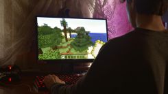 guy on computer playing minecraft