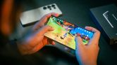 Person Playing Genshin Impact on Phone