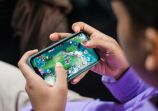 Person Playing Games on Smartphone