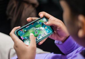 Person Playing Games on Smartphone