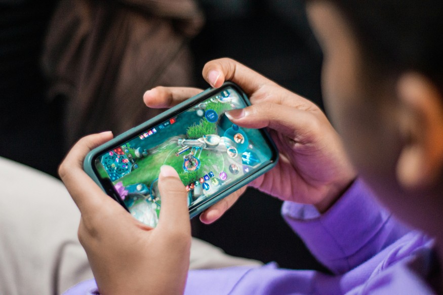 Person Playing Games on Smartphone