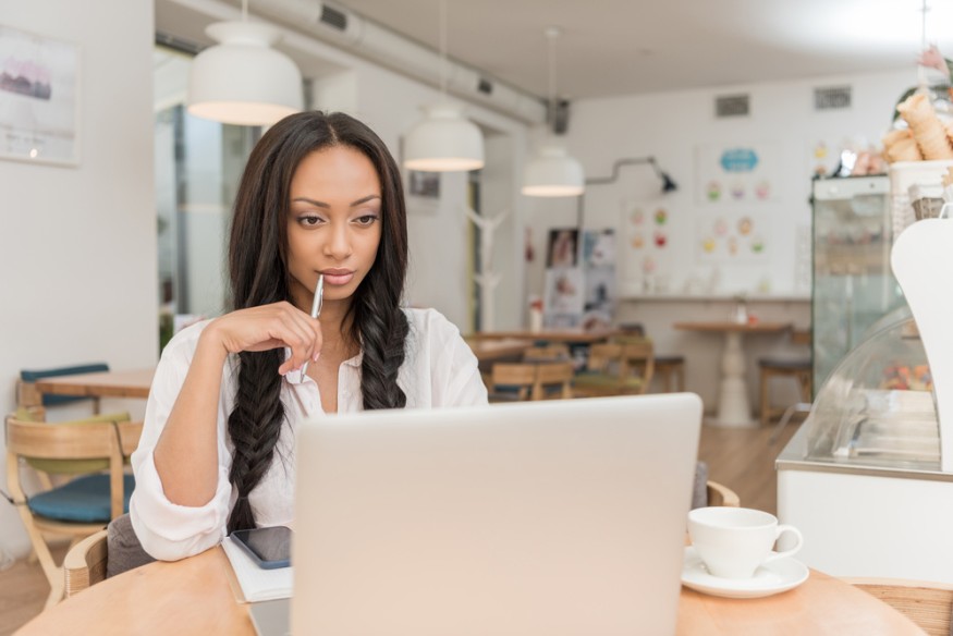 Businesswoman with laptop at cafe